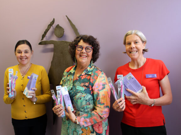Karen and Lyn from Catherine House with ADFi board member Jan Miller holding donated products from the Australian Dental Foundation at Catherine House.