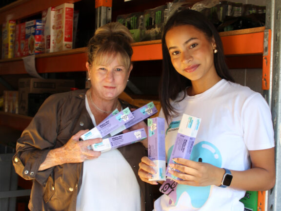 Australian Dental Foundation staff holding toothpaste.