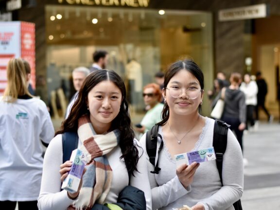 Two individuals holding Australian Dental Foundation toothpaste.